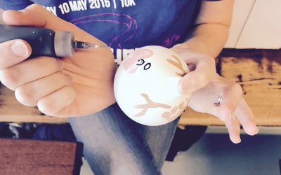 painting the detail on a Christmas bauble