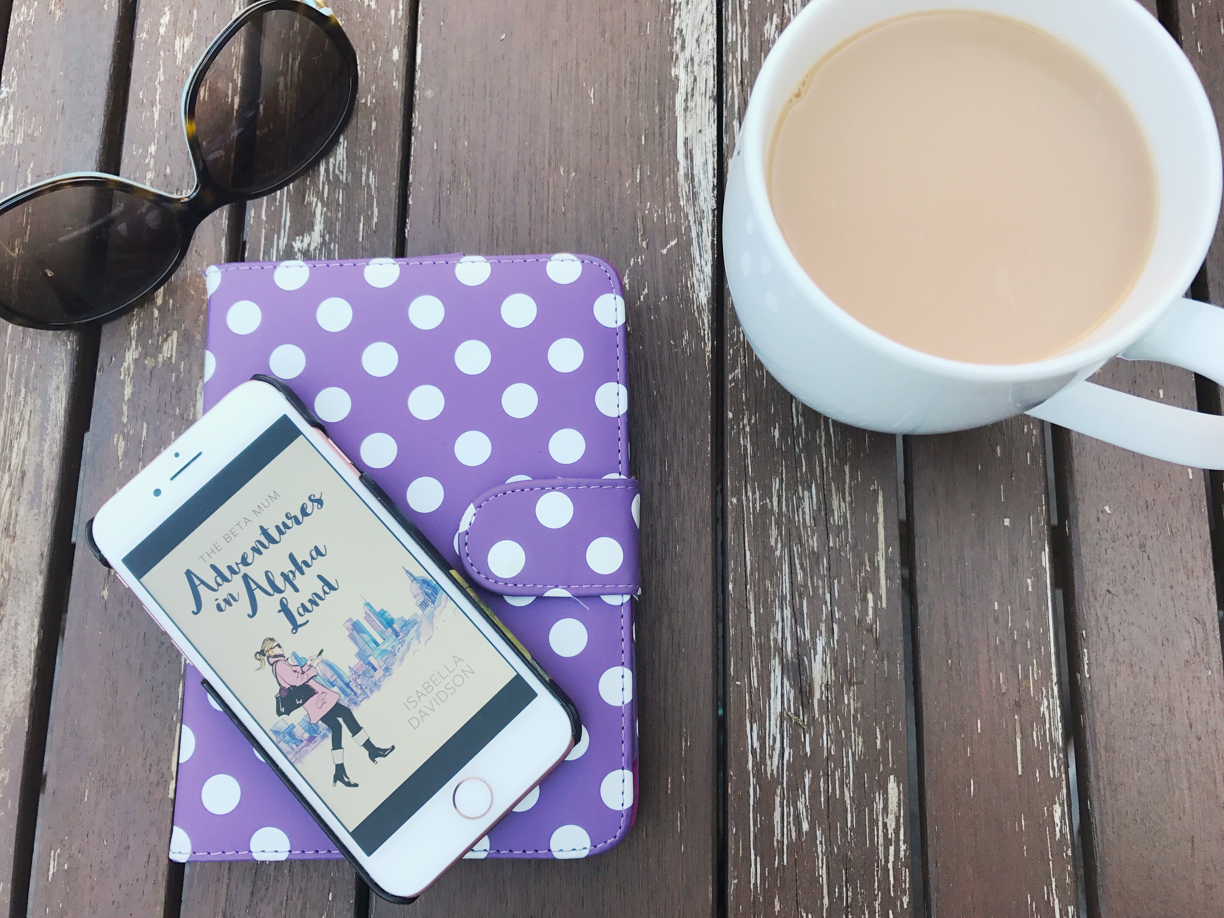 The Beta Mum on iPhone with a cup of tea