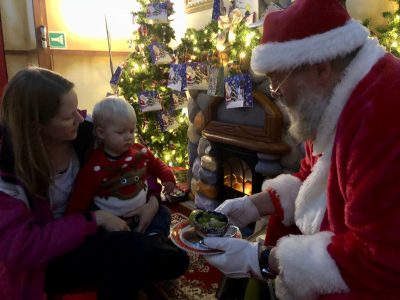 Tall Boy discussing reindeer food with Santa