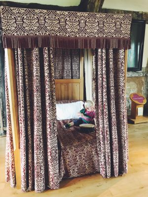 Tall Boy drumming on a four poster bed, Ordsall Hall