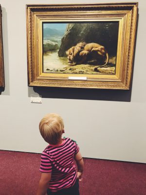 Tall Boy looking at a lion painting, Salford Art Gallery