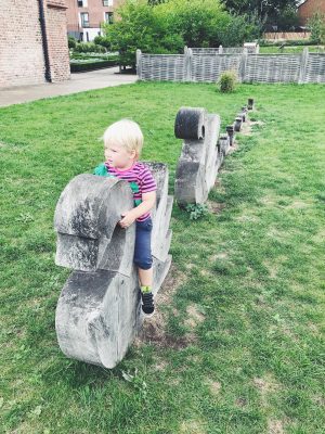 Tall Boy sitting on wooden swans at Ordsall Hall