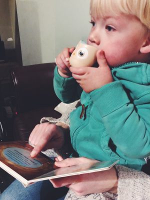 Tall Boy reading Sounds of the Forest and blowing owl whistle