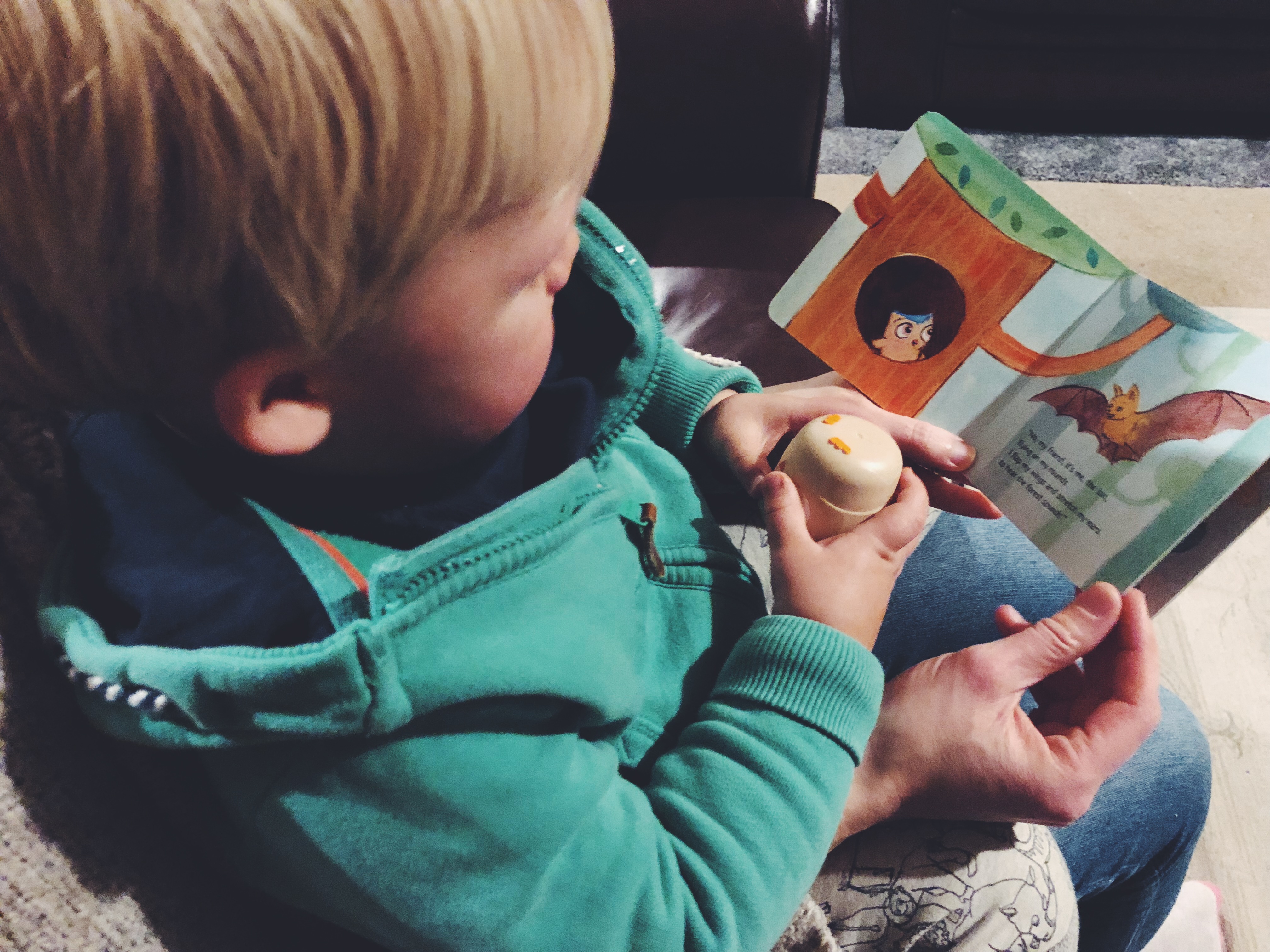 Tall Boy reading Sounds of the Forest and holding owl whistle