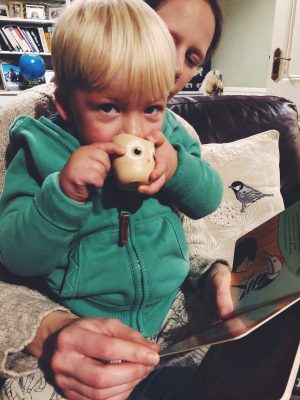 Tall Boy reading Sounds of the Forest and blowing owl whistle